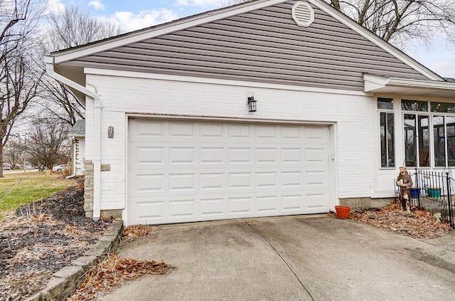 garage with concrete driveway