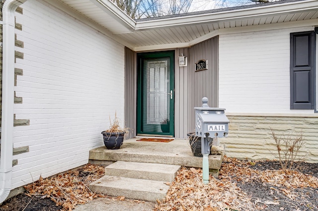 doorway to property with brick siding