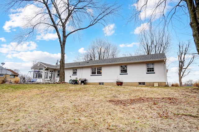 back of house with a lawn