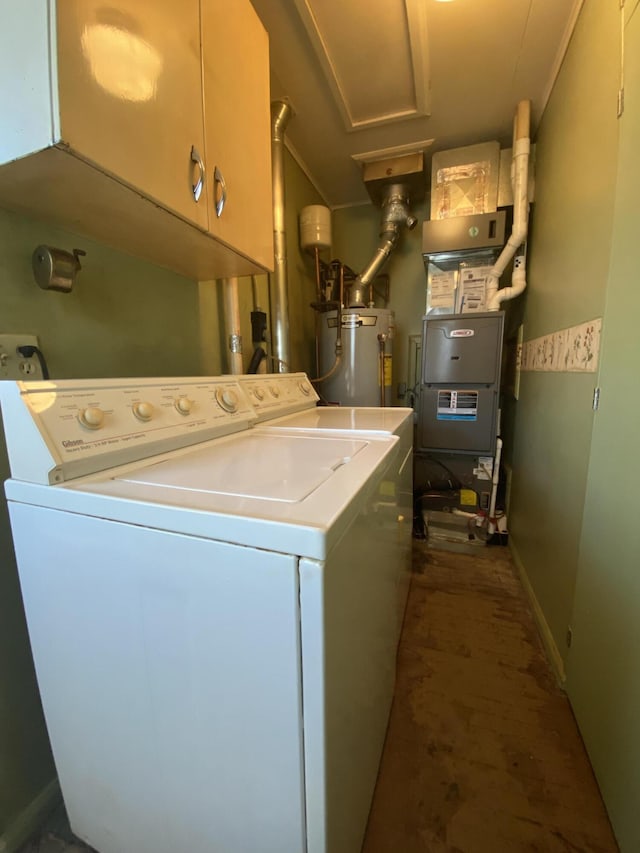 clothes washing area with heating unit, water heater, cabinet space, and washing machine and clothes dryer