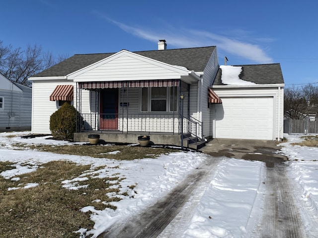 view of front of house with an attached garage, a shingled roof, and a porch