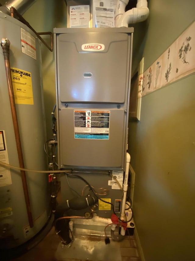 utility room with gas water heater and heating unit