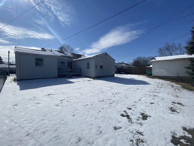 snow covered property featuring fence