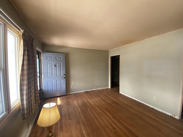 foyer with dark wood finished floors and baseboards