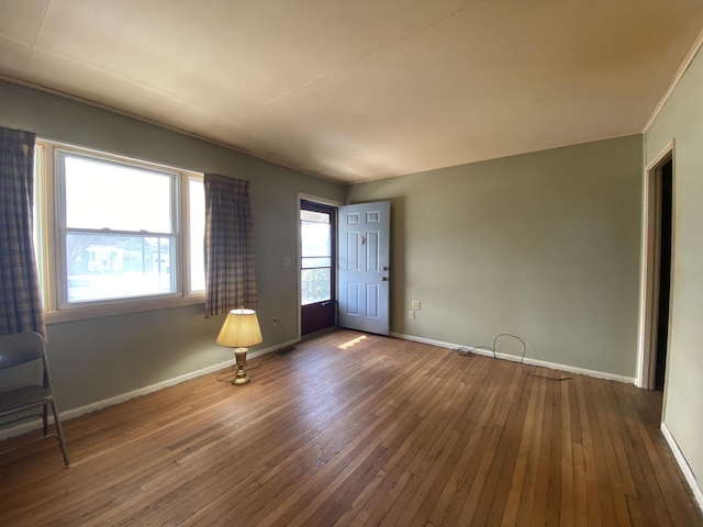 empty room with dark wood-style floors and baseboards