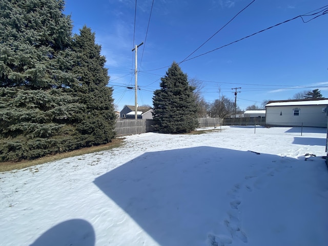 snowy yard with fence