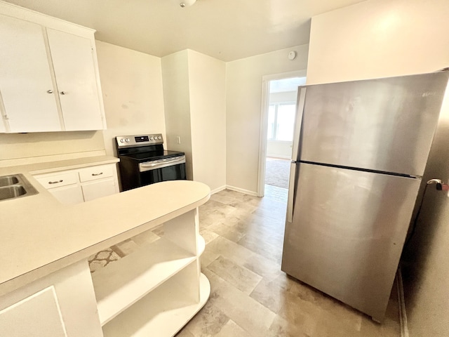 kitchen with open shelves, stainless steel appliances, light countertops, white cabinets, and a sink