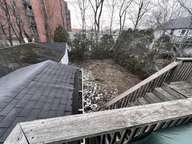 exterior details with a shingled roof and stairway