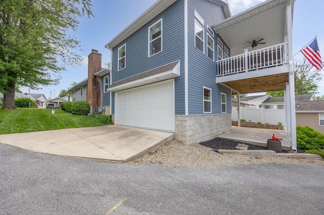 11177 Sassafrass Rd, Lakeview, OH 43331 - view of side of property with a garage, a ceiling fan, a yard, a balcony, and driveway