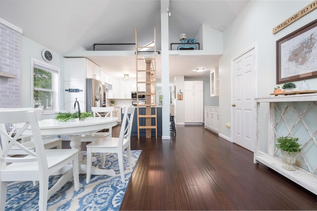 11177 Sassafrass Rd, Lakeview, OH 43331 - dining space featuring dark wood-type flooring and high vaulted ceiling