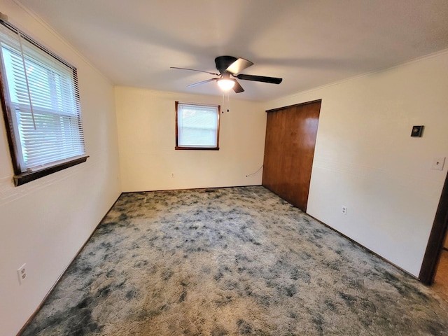 2169 State Route 49, Arcanum, OH 45304 - unfurnished bedroom featuring crown molding, carpet floors, ceiling fan, and a closet