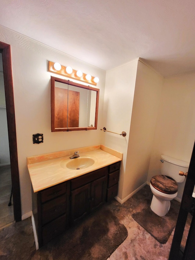2169 State Route 49, Arcanum, OH 45304 - half bathroom featuring vanity, baseboards, and toilet