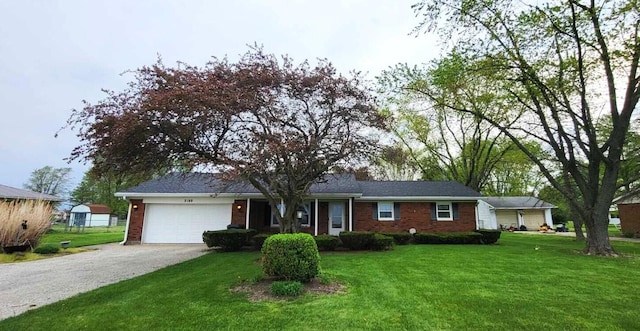 2169 State Route 49, Arcanum, OH 45304 - single story home featuring an attached garage, gravel driveway, a front yard, and brick siding