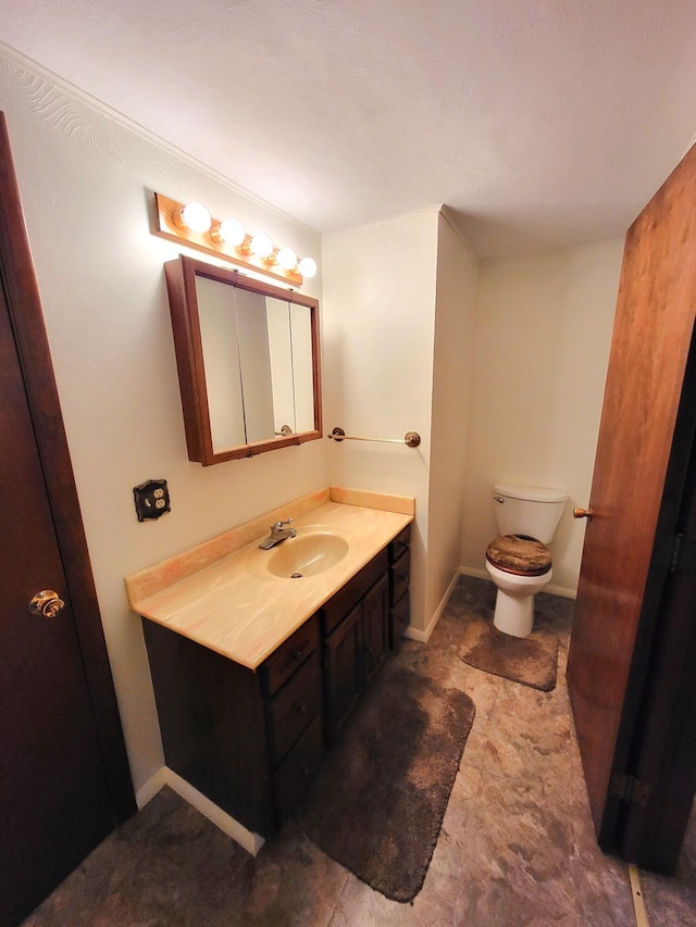2169 State Route 49, Arcanum, OH 45304 - bathroom with toilet, baseboards, and vanity