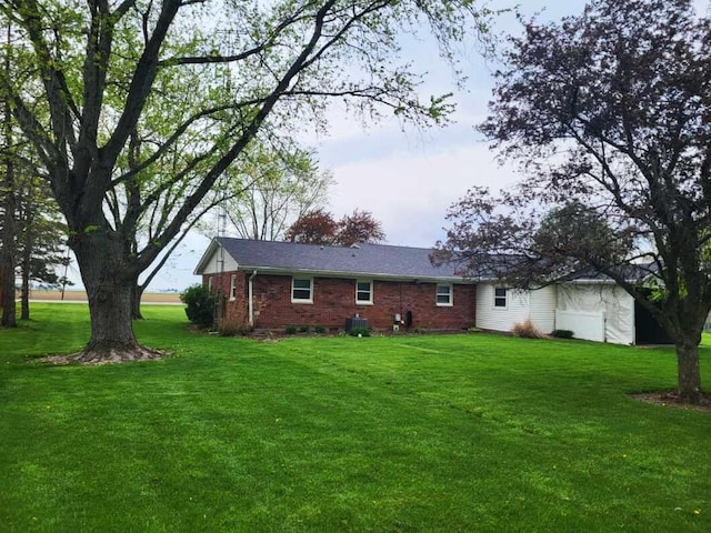 2169 State Route 49, Arcanum, OH 45304 - rear view of house with brick siding, central AC unit, and a yard