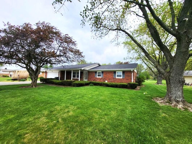 2169 State Route 49, Arcanum, OH 45304 - ranch-style home featuring a garage, a front yard, and brick siding