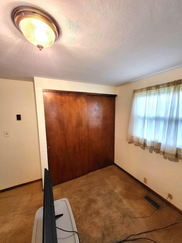 2169 State Route 49, Arcanum, OH 45304 - unfurnished bedroom with carpet floors, baseboards, visible vents, and a closet