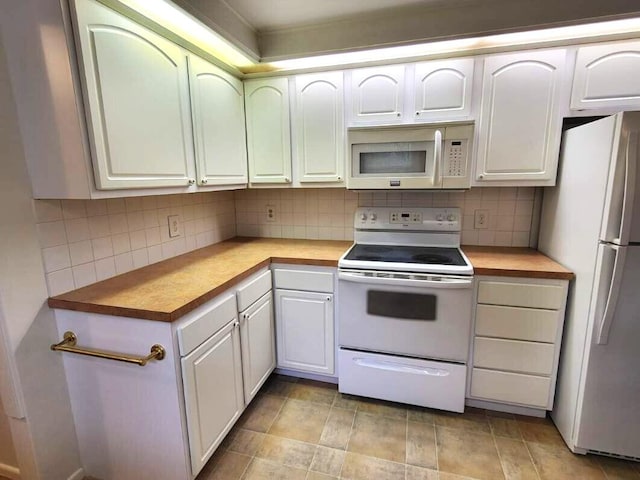 2169 State Route 49, Arcanum, OH 45304 - kitchen featuring white appliances, white cabinetry, and decorative backsplash