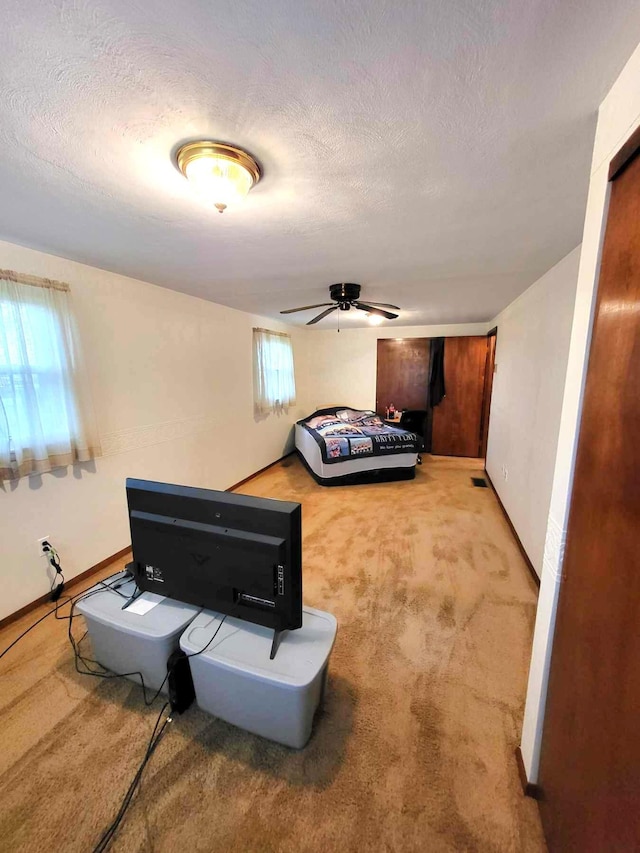 2169 State Route 49, Arcanum, OH 45304 - bedroom with baseboards, a textured ceiling, carpet, and a ceiling fan
