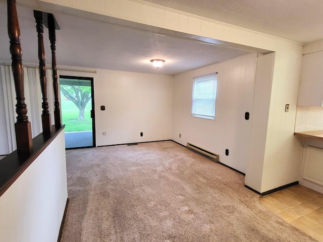 2169 State Route 49, Arcanum, OH 45304 - empty room with a baseboard radiator, baseboards, plenty of natural light, and light colored carpet