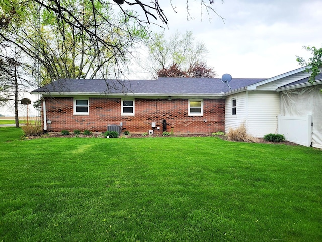 2169 State Route 49, Arcanum, OH 45304 - back of house with brick siding, central AC, and a yard