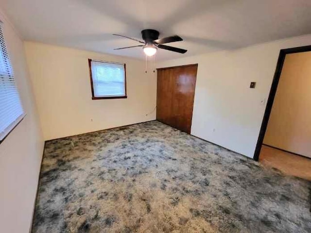 2169 State Route 49, Arcanum, OH 45304 - unfurnished bedroom featuring a closet, a ceiling fan, and carpet