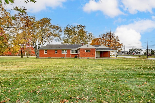 rear view of house featuring a yard