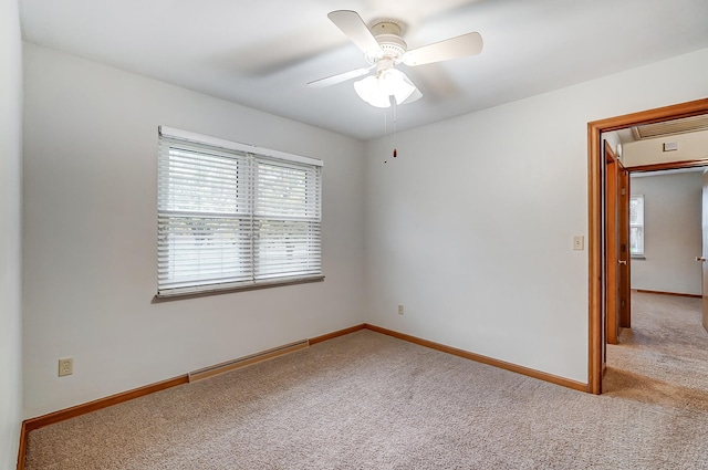 unfurnished room with light colored carpet and ceiling fan