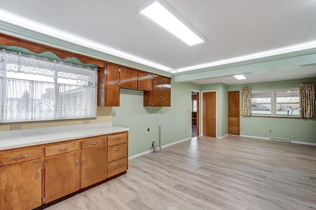 kitchen featuring baseboard heating and light hardwood / wood-style flooring