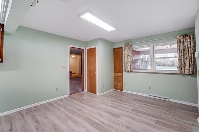 spare room featuring light wood-type flooring