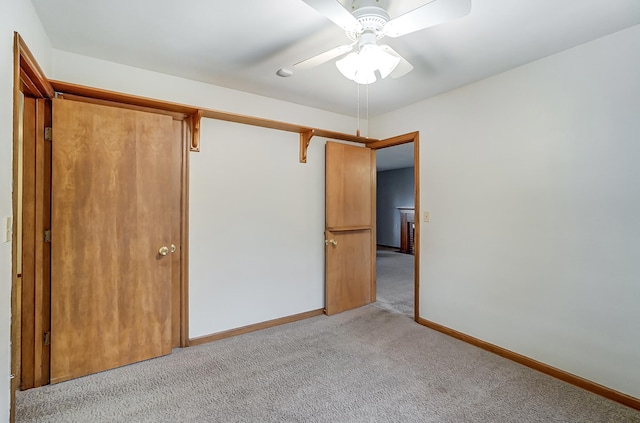 unfurnished bedroom with ceiling fan, a closet, and light carpet