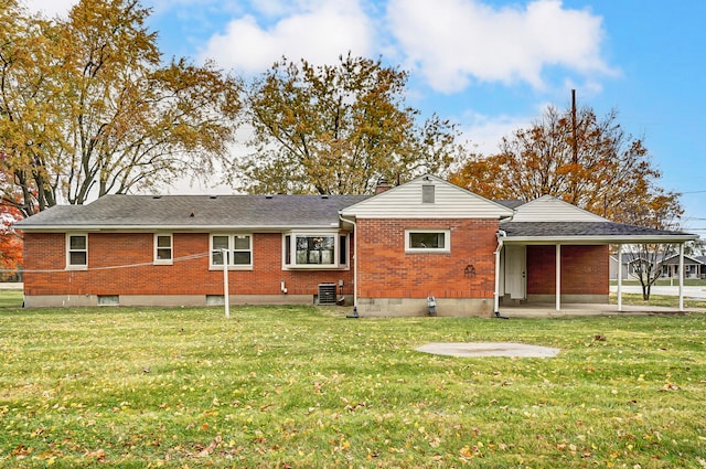 back of property with a lawn and central air condition unit