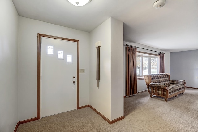 view of carpeted foyer entrance