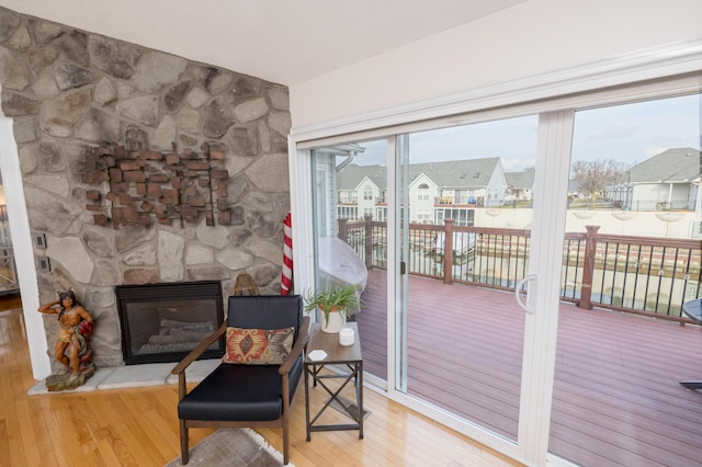 doorway featuring hardwood / wood-style flooring and a fireplace