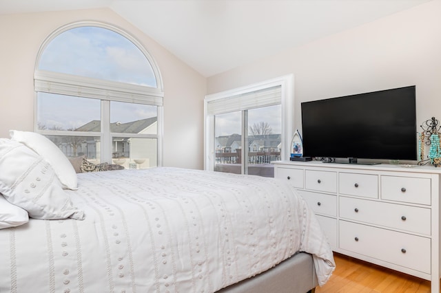 bedroom with lofted ceiling and light hardwood / wood-style flooring