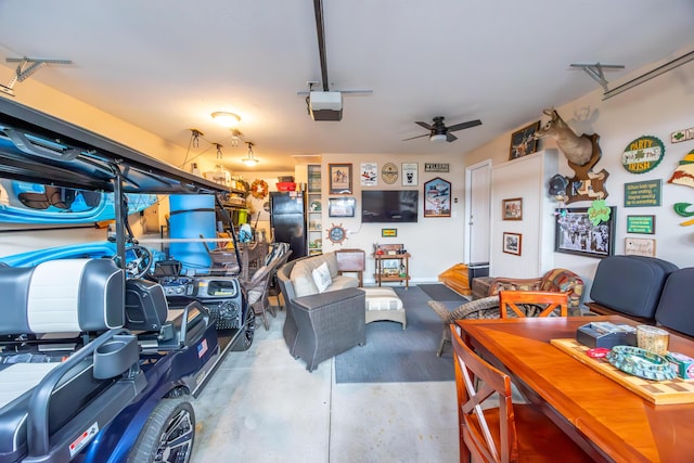 garage with black refrigerator, ceiling fan, and a garage door opener