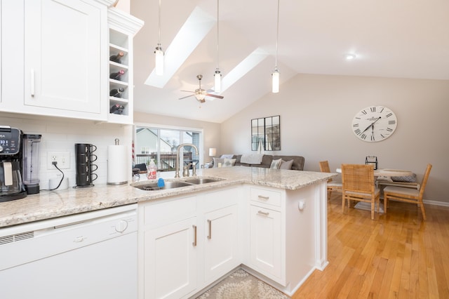 kitchen with decorative light fixtures, sink, backsplash, white cabinets, and white dishwasher