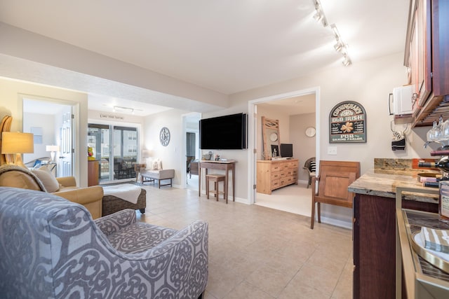 tiled living room featuring track lighting