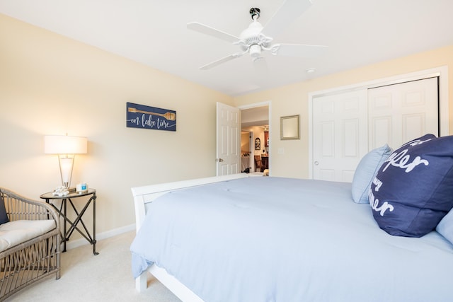 carpeted bedroom with ceiling fan and a closet