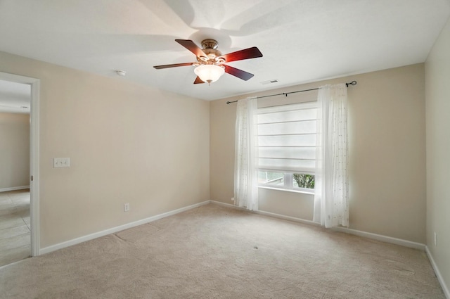 unfurnished room featuring visible vents, baseboards, ceiling fan, and light carpet