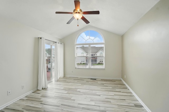 unfurnished room with plenty of natural light, ceiling fan, lofted ceiling, and light wood-type flooring