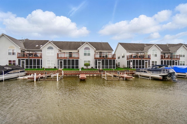 view of dock featuring a water view and a residential view
