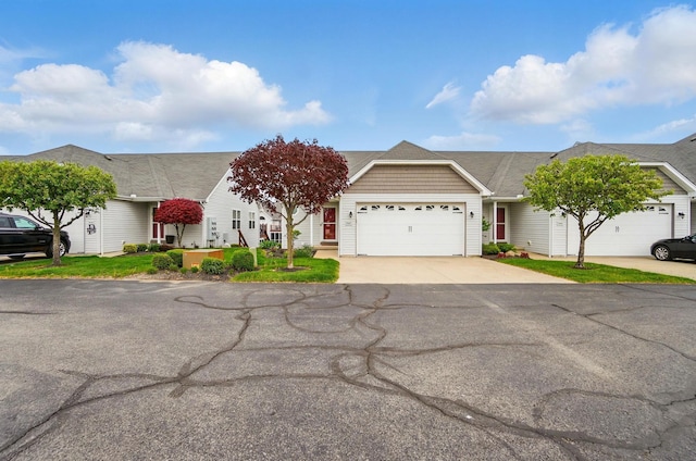 single story home with a garage and concrete driveway
