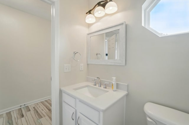 half bathroom with toilet and vanity