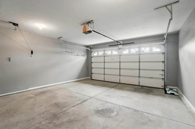 garage with baseboards and a garage door opener
