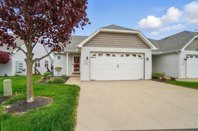view of front of house featuring driveway, a front lawn, and a garage