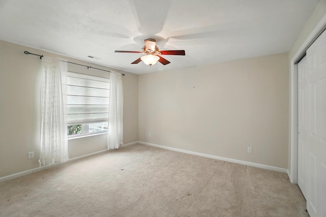 unfurnished bedroom featuring carpet flooring, a ceiling fan, baseboards, and a closet