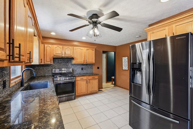 kitchen featuring light tile patterned flooring, sink, dark stone countertops, decorative backsplash, and stainless steel appliances