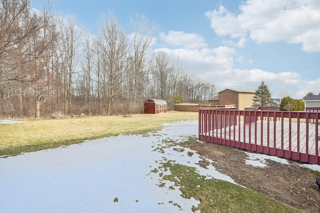 view of yard featuring a wooden deck and a shed