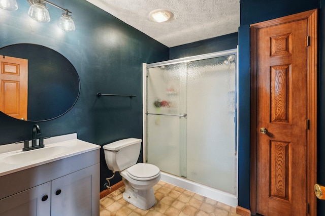 bathroom featuring toilet, vanity, a textured ceiling, and walk in shower